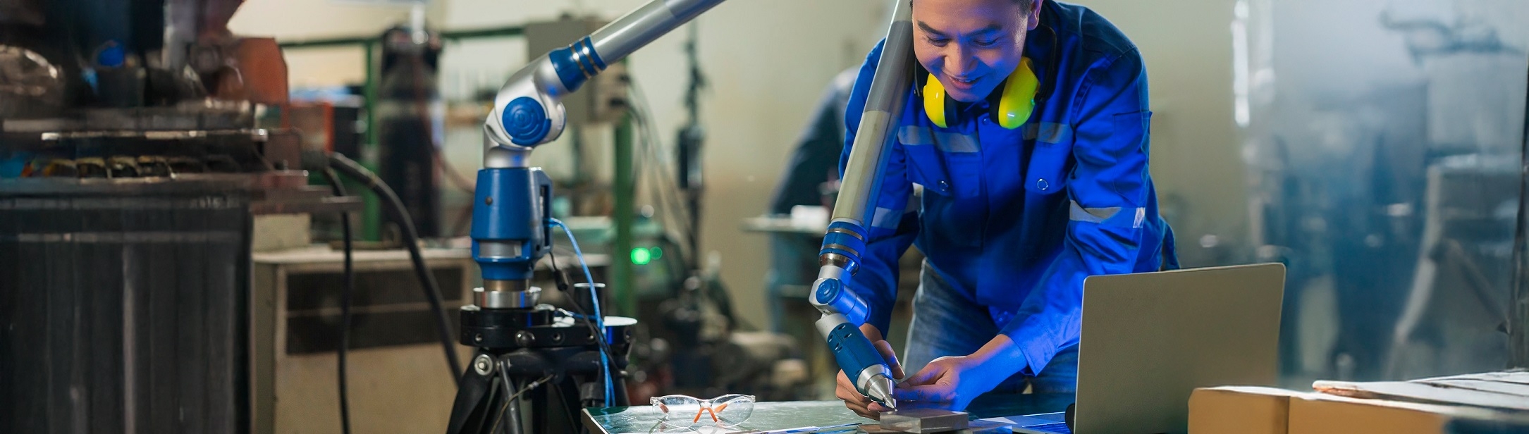asian-male-engineer-specialist-with-measuring-machine-with-manipulator-armthreedimensional-coordinat